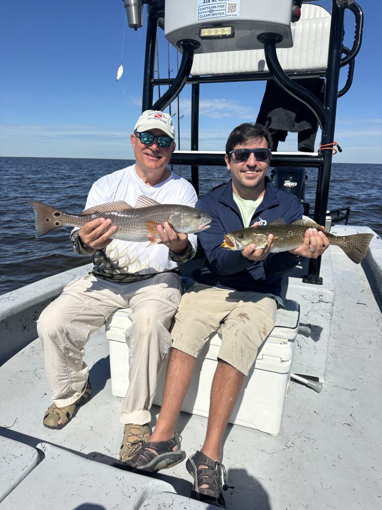 Two anglers showing a Redfish and Speckled Trout aboard an inshore charter on Charlotte Harbor.