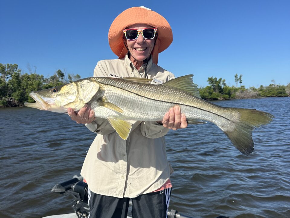 Angler holding a trophy Snook on a Boca Grande inshore charter near Gasparilla Sound.