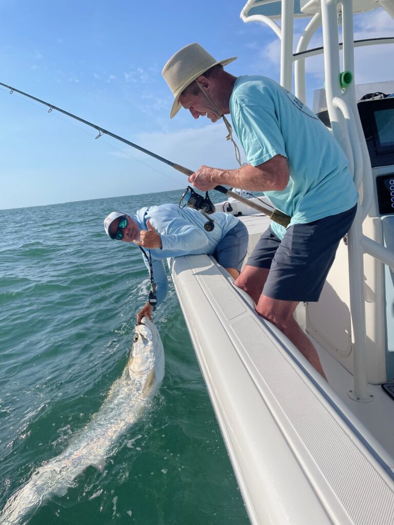 captain-danny-latham-boca-grande-tarpon-charter.jpg Captain Danny Latham releasing a large Tarpon alongside his charter guest in Boca Grande, Florida — showcasing expert local guiding and conservation-focused fishing practices.