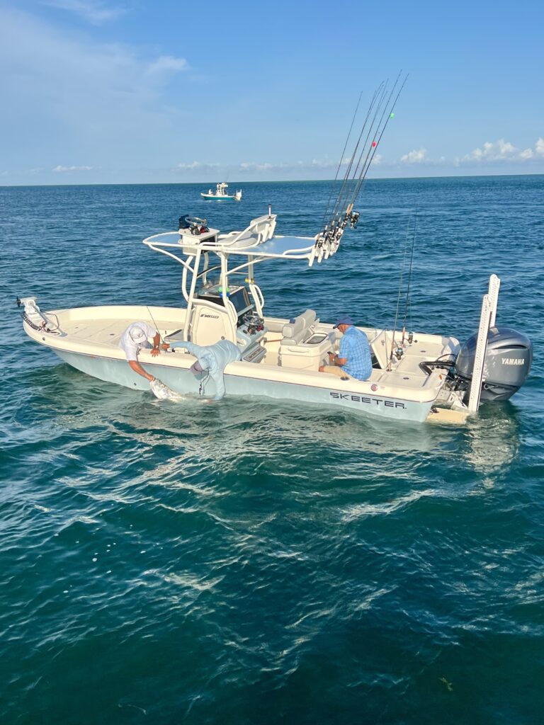 Captain Danny Latham’s Skeeter 2550 Bay Boat – Boca Grande Tarpon Fishing | ReelFishing Charters Captain Danny Latham releases a Tarpon beside his Skeeter 2550 Bay boat powered by a Yamaha F300 during a Boca Grande fishing charter with ReelFishing Charters.