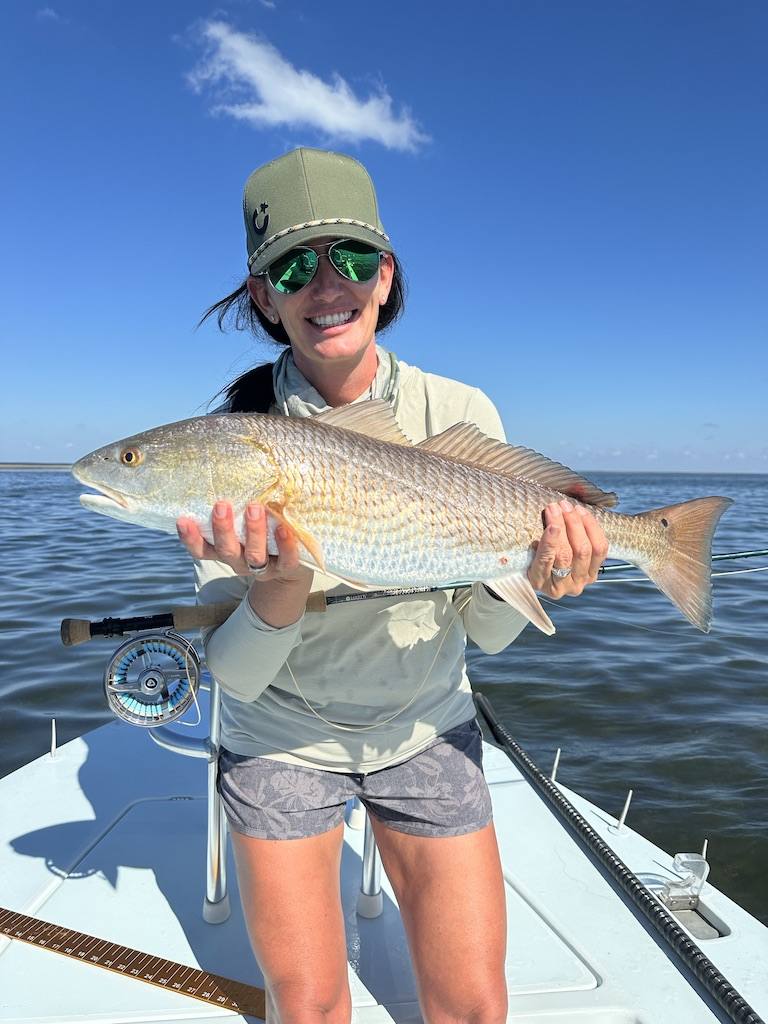 Boca Grande Fly Fishing Redfish Charter Angler holding a redfish caught on fly gear during a Boca Grande fly fishing charter