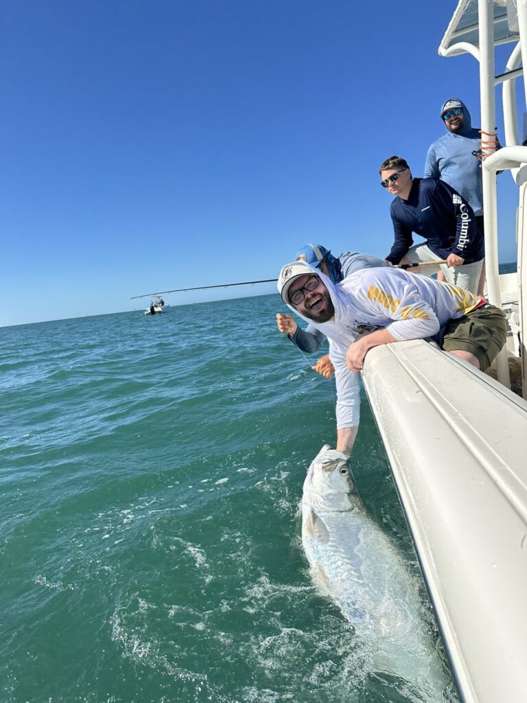 Rare January tarpon Boca Grande fishing charter Anglers releasing a tarpon during a rare January bite off Boca Grande with ReelFishing Charters