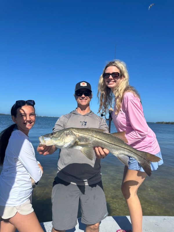 Family Snook Fishing Charter in Punta Gorda Family with a large Snook on a Punta Gorda fishing charter